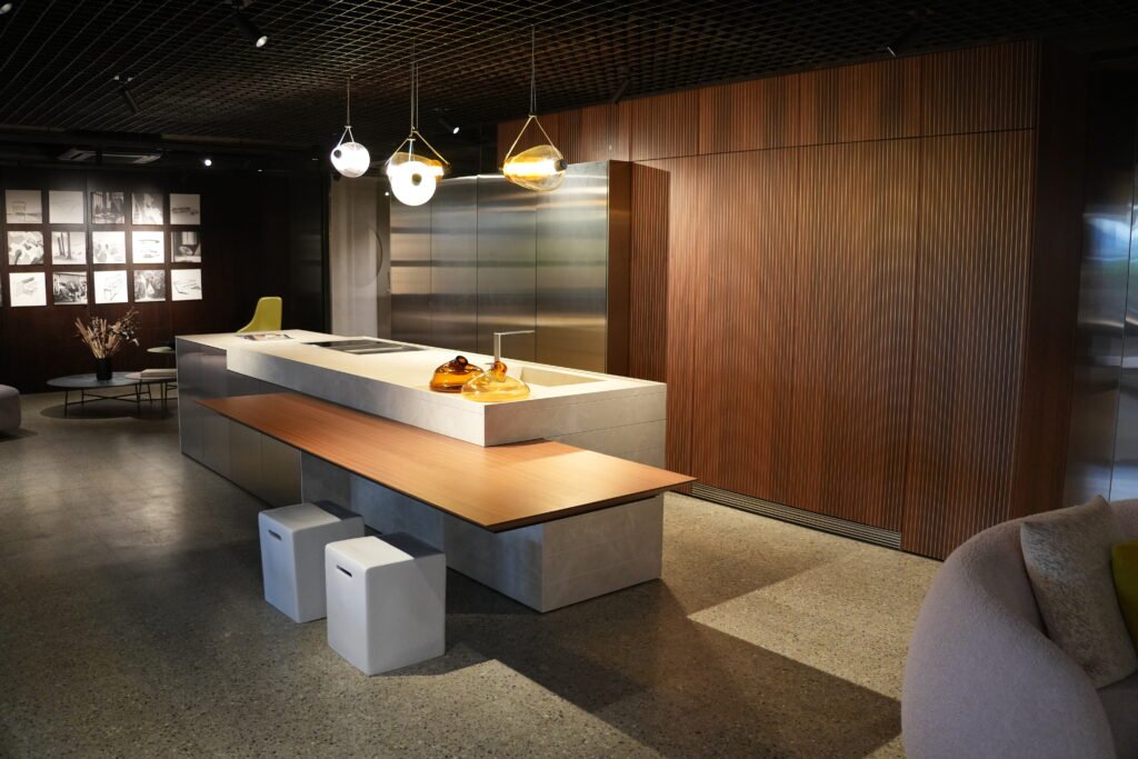 Snaidero Elementi kitchen island with waterfall counter on a single copper-toned leg, Bangalore showroom